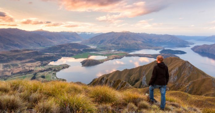 Man looking at scenic landscape, New Zealand