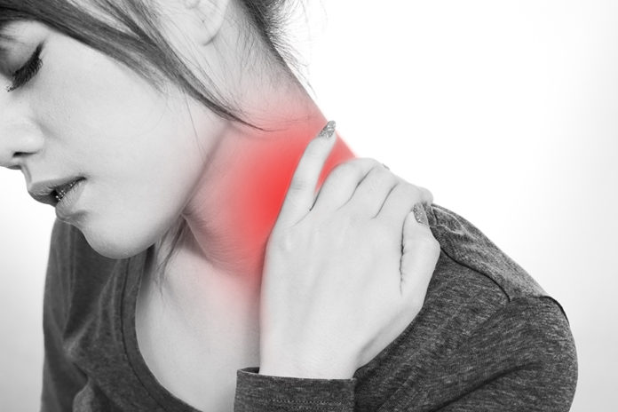Young woman with a pain in the neck