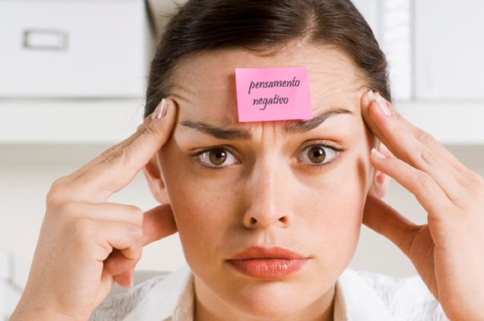 Businesswoman with sticky note on forehead