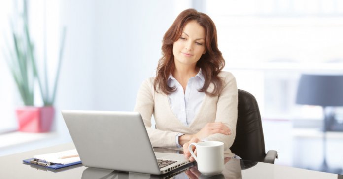 Beautiful business woman with laptop in office