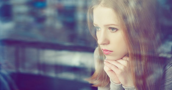 thoughtful sadness girl is sad at window