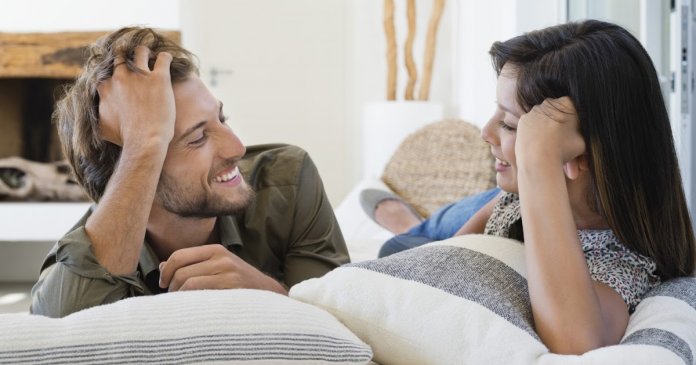 Couple lying on the bed and smiling