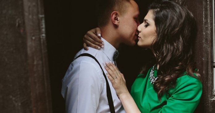 man and woman hug in the door