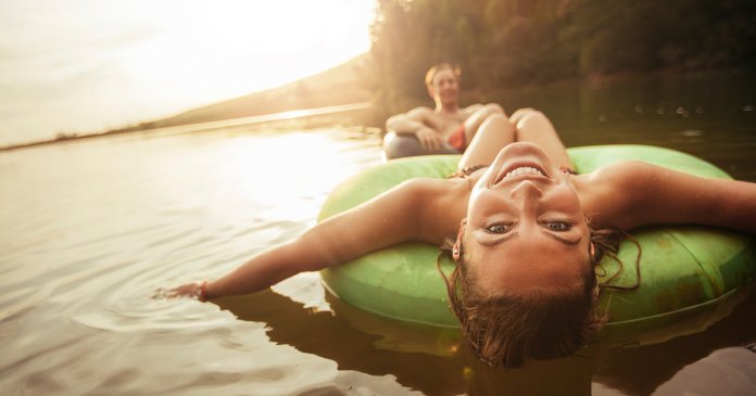 Young girl in lake on innertube
