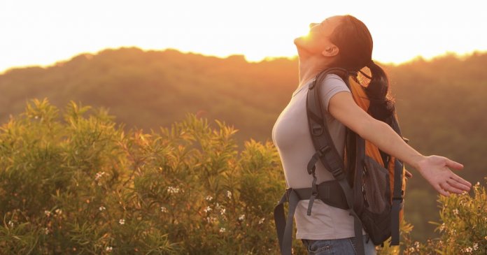 woman hiker excited with sunrise