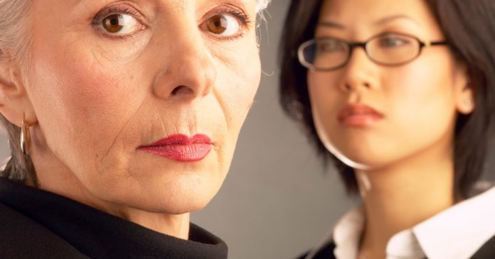 Businesswoman posing by colleague