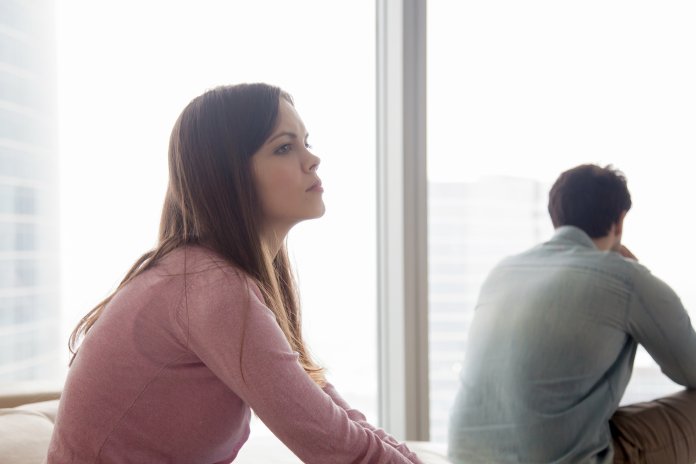 Unhappy couple ignoring each other after argument, problems in relationship