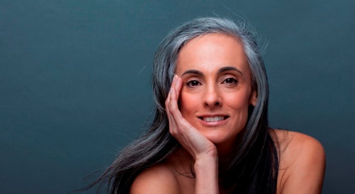 Mature woman with hand on chin