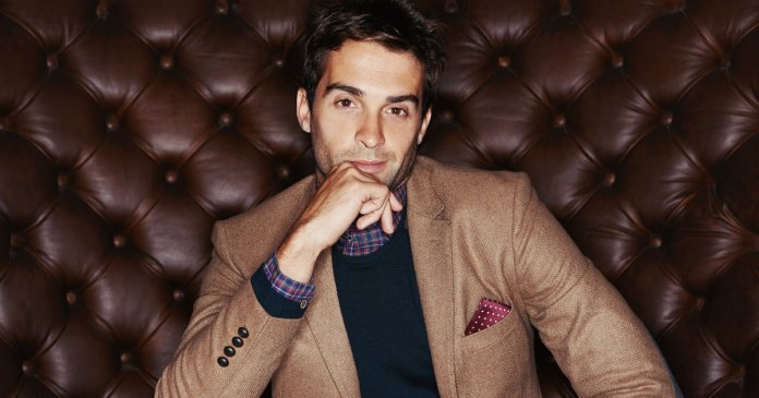 Portrait of a stylishly dressed young man sitting in a lounge