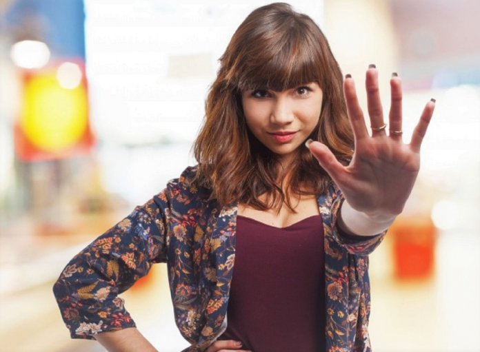 woman-with-a-hand-extended-in-sign-of-stop_1187-3179