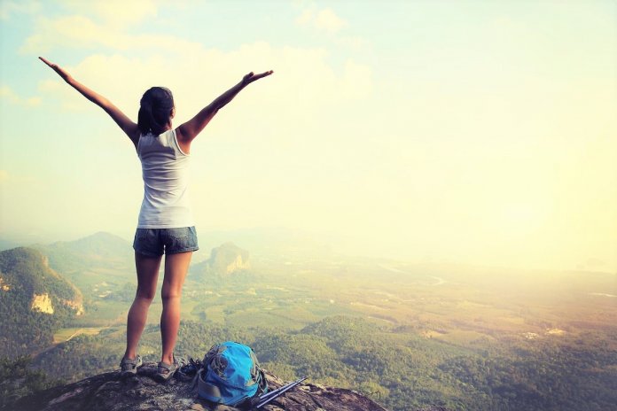 cheering-hiking-woman-on-mountain-peak-000061532646_Large