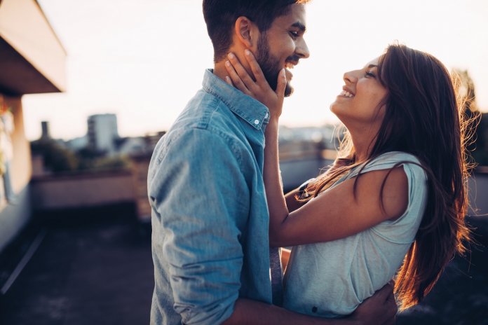 Beautiful couple in love dating outdoors and smiling