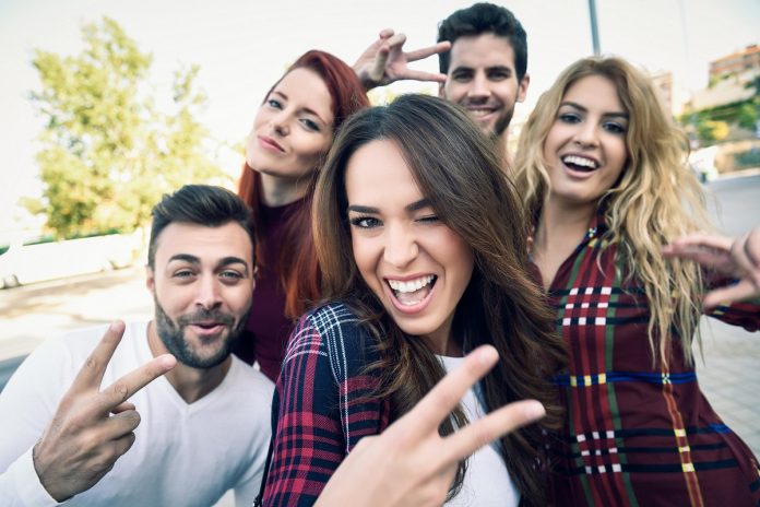 Group of friends taking selfie in urban background