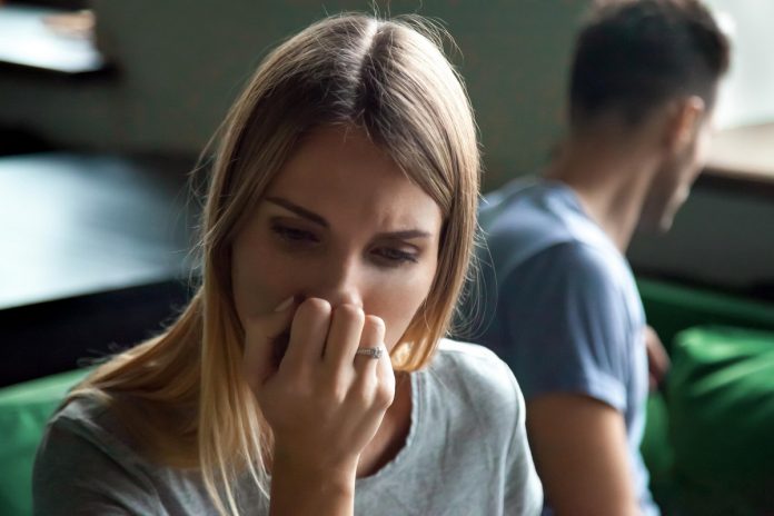Portrait of upset offended frustrated woman with man